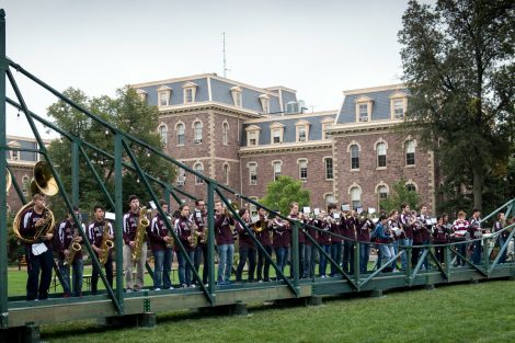Students stand on a replica bridges of the Free Bridge on the Quad. The bridge was created by engineering students and assembled by any member of the community wishing to join during Homecoming.