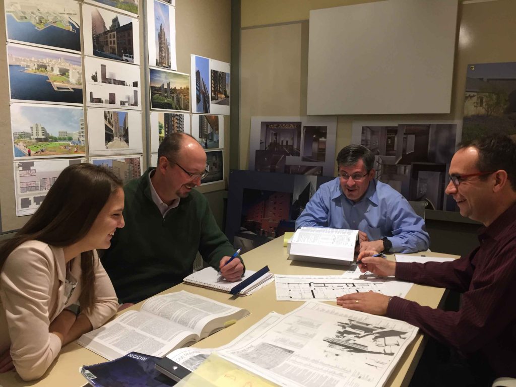 Rebecca Blocker ’20 with Christopher Blakelock ’90 amd two other men employees at Cecil Baker + Partners Architects in Philadelphia