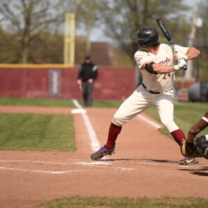 A baseball player steps up at bat.