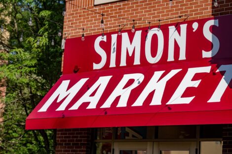 A sign reads Simon's Market on a building.