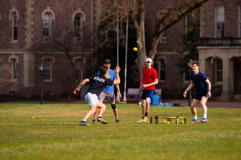 Four students play a game on the Quad