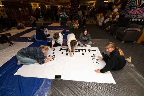 Students make banners for the Rivalry.